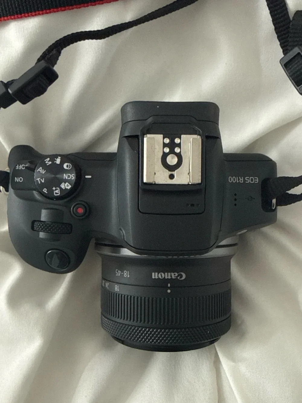 Canon EOS R100 Compact Mirrorless Camera with Red-Trim Strap – Black
